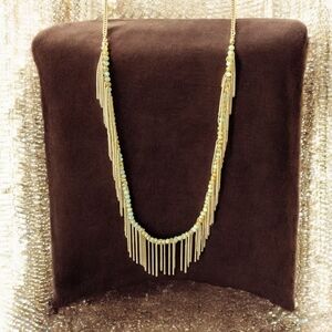 Freedom gold and green long necklace with a boho feeling fringe.